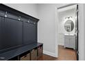 Well-organized mudroom features a bench with storage and access to a half bathroom at 369 Roberts Ridge Dr, Cary, NC 27513