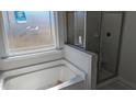 Bathroom featuring a soaking tub and separate shower with tile surround at 39 Braddock Ct, Garner, NC 27529