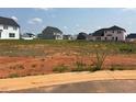 View of the Adams Homes community showing an empty lot ready to build with other homes in the background at 39 Braddock Ct, Garner, NC 27529