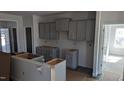 Unfinished kitchen with gray cabinets, providing a blank canvas for customization and personalization at 39 Braddock Ct, Garner, NC 27529