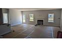 Spacious living room featuring a fireplace and ample natural light from windows at 39 Braddock Ct, Garner, NC 27529