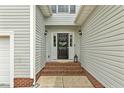 Close-up of the home's front door with wreath, sidelights, and brick steps at 40 Breckenridge Pl, Dunn, NC 28334