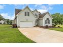 Inviting home boasts an attached garage, long driveway, and pleasant landscaping at 40 Breckenridge Pl, Dunn, NC 28334