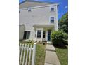 Two-story townhome featuring a private entrance and a well-manicured lawn with a charming white picket fence at 401 Coalinga Ln # 106, Raleigh, NC 27610