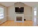 Bright living room with hardwood floors, a fireplace with a modern mantel and neutral wall colors at 419 Jera Dr, Garner, NC 27529