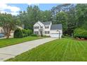 Attractive two-story home boasting a well-manicured lawn and long concrete driveway at 4329 Hawksong Pl, Cary, NC 27518