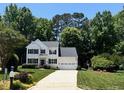 Inviting two story home featuring lush landscaping, green lawn, and paved driveway at 4329 Hawksong Pl, Cary, NC 27518