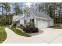 Well-maintained home with an attached two-car garage, complemented by lush landscaping and a paved driveway at 4416 Thistlehill Ct, Raleigh, NC 27616
