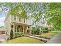View of the charming two-story home featuring a welcoming front porch and maintained landscaping at 4605 All Points View Way, Raleigh, NC 27614