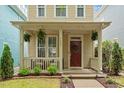 Welcoming covered front porch with hanging plants and a cozy seating area at 4605 All Points View Way, Raleigh, NC 27614