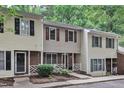 Inviting townhome exterior with brick details, manicured shrubbery, and quaint white picket fence at 4658 Fawnbrook Cir, Raleigh, NC 27612