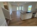 Open-concept living room with hardwood floors, a staircase, and a view into the modern kitchen at 48 Freedom Heights Ln # 150, Smithfield, NC 27577