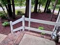 Brick patio with white railings and decorative potted plants, providing a charming outdoor area at 516 Ryan Rd, Cary, NC 27511