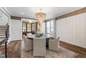 Bright dining room featuring a chandelier, hardwood floors, and a decorative rug under the table at 523 Vick Ave, Raleigh, NC 27612