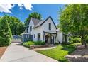 Beautifully landscaped, two-story home featuring shake siding, manicured lawn, and a detached two-car garage at 523 Vick Ave, Raleigh, NC 27612