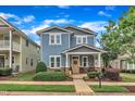 Charming two-story home with a welcoming front porch and professionally landscaped yard at 533 Duchart Ln, Fuquay Varina, NC 27526