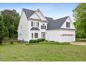 Charming two-story home with a well-manicured lawn and attached two car garage at 5608 Scottish Hills Dr, Holly Springs, NC 27540