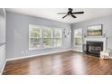 Bright living room with hardwood floors, fireplace, ceiling fan, and lots of natural light at 5637 Yates Garden Ln, Raleigh, NC 27606