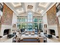 Bright living room with high ceilings, a wall of windows, and elegant decor at 6510 New Market Way, Raleigh, NC 27615
