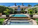 Beautiful backyard pool area with lush landscaping and lounging space at 6510 New Market Way, Raleigh, NC 27615