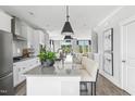 Spacious kitchen with stainless appliances, a long island, and barstool seating overlooking the backyard at 672 Bandon Aly, Cary, NC 27513