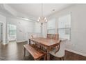 Bright dining room features a rustic wood table set and elegant chandelier lighting at 68 Holly Berry Ln, Durham, NC 27703