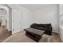 Cozy living room showcasing a comfortable couch, coffee table, and neutral carpet at 68 Holly Berry Ln, Durham, NC 27703