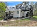 Two-story home with black trim and an elevated deck area, surrounded by a natural landscape at 852 Fred Wilder Rd, Franklinton, NC 27525