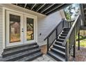 Stairway leading up to the deck, complemented by glass panel french doors and natural lighting at 852 Fred Wilder Rd, Franklinton, NC 27525