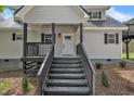 Staircase leading to the main entrance, framed by black trim and a well-manicured lawn at 852 Fred Wilder Rd, Franklinton, NC 27525