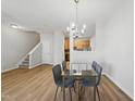Charming dining area features chandelier lighting and flows seamlessly into the living room and kitchen at 8621 Neuse Club Ln # 106, Raleigh, NC 27616