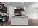 Modern kitchen with granite countertops, stainless steel appliances, and dark wood cabinets at 1102 Latitude Dr, Durham, NC 27713