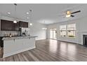 Open-concept living area with hardwood floors, abundant natural light, and a view of the backyard at 1102 Latitude Dr, Durham, NC 27713