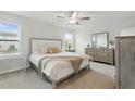 Comfortable bedroom with soft carpet, neutral decor, a ceiling fan and ample natural light at 1112 Prewitt Ranch Dr, Holly Springs, NC 27540