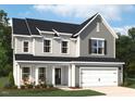 Charming two-story home featuring a gray exterior, black shutters, and a welcoming front porch at 112 Moonflower Ln # Homesite 267, Wilson's Mills, NC 27520