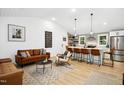 Open concept living room featuring a kitchen island, neutral decor, and modern furnishings at 117 Bertie Dr, Raleigh, NC 27610