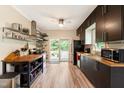 Modern kitchen with dark cabinets, butcher block countertops, and stainless steel appliances at 119 Danforth Dr, Cary, NC 27511