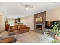 Inviting living room with a stone fireplace, plush seating, and a ceiling fan at 119 Danforth Dr, Cary, NC 27511