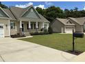 Inviting home with charming details, green lawn, and a separate garage for added space and convenience at 119 Hunterwood Pl, Benson, NC 27504