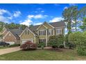 Traditional two-story home with verdant lawn, attached garage and mature trees at 1237 Shirehall Park Ln, Wake Forest, NC 27587