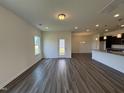 Bright and airy living room with wood-look floors and an open layout connecting to the kitchen at 128 Bruce Dr, Dunn, NC 28334