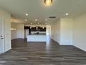Spacious open-concept living room with wood-look floors flowing into the kitchen area at 128 Bruce Dr, Dunn, NC 28334