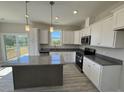 Beautiful kitchen featuring stainless appliances, gray countertop island, and hardwood floors at 140 Brookhaven Dr, Spring Hope, NC 27882