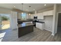 Beautiful kitchen featuring stainless appliances, gray countertop island, and hardwood floors at 140 Brookhaven Dr, Spring Hope, NC 27882