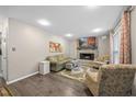 Inviting living room with a brick fireplace, comfortable seating, and a mounted television for entertainment at 151 Lake Pine Dr, Cary, NC 27511