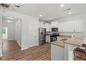 Modern kitchen features stainless steel appliances, granite countertops, and a breakfast bar for casual dining at 1728 Shady Oaks Dr, Wendell, NC 27591