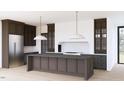 Gourmet kitchen boasts custom cabinets, large island, stainless appliances, designer lighting, and a marble backsplash at 1808 Stream Manor Ct, Wake Forest, NC 27587
