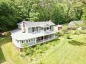 Aerial view of the home showing the outdoor living space, including the porch and landscaped grounds at 183 Birnamwood Dr, Chapel Hill, NC 27516