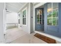 Inviting home entrance with a gray front door, leading onto a covered porch area at 20 Scotland Dr, Youngsville, NC 27596