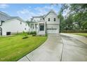 Beautifully landscaped two-story home with a covered front porch and an attached two-car garage at 20 Scotland Dr, Youngsville, NC 27596